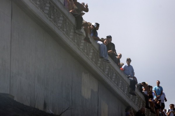 People hanging off the 105 Freeway watching the landing