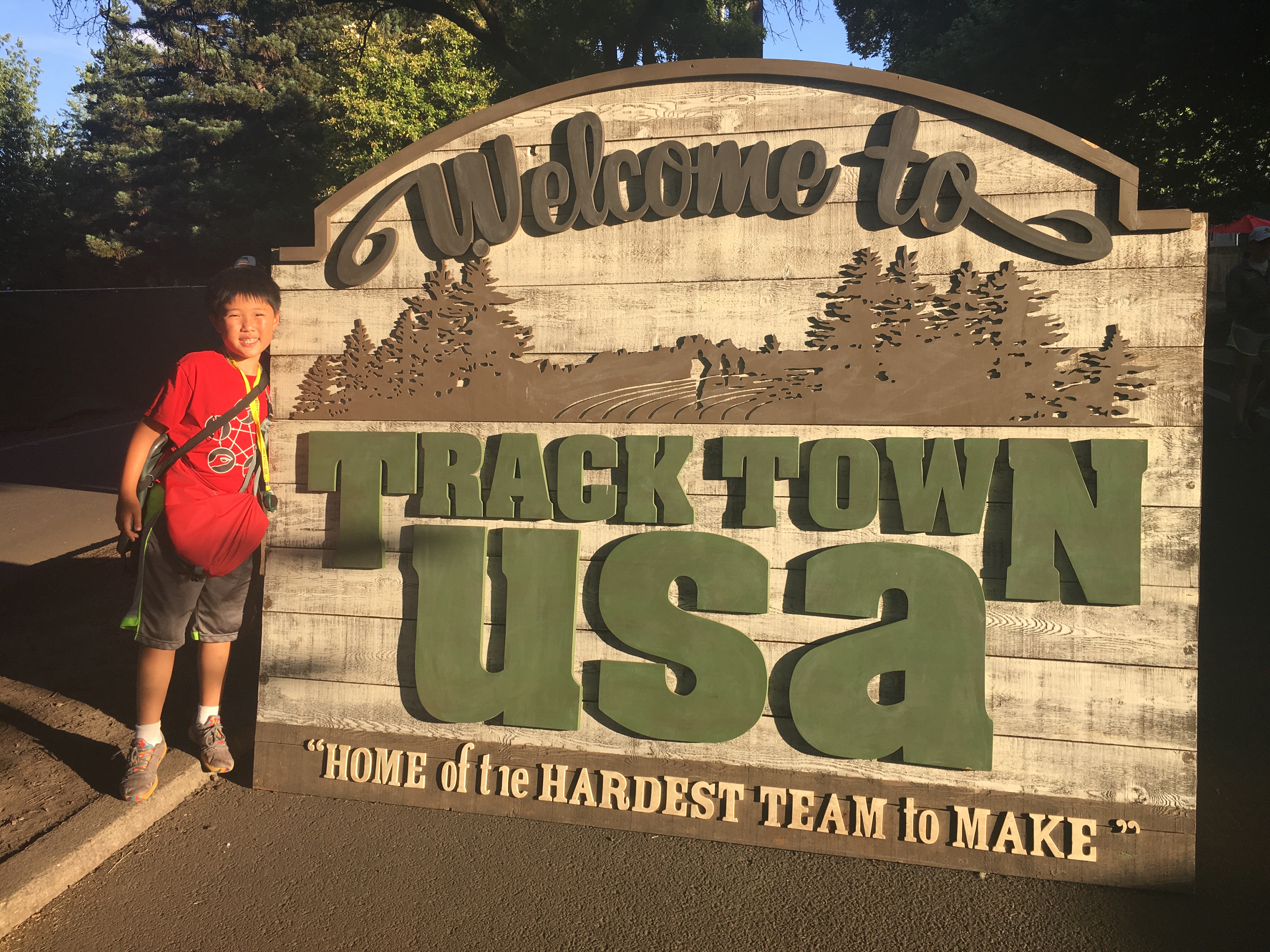 Matthew in front of a TrackTown sign at the entrance to the Olympic Trials
